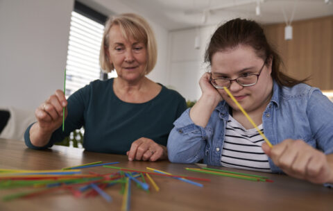down-syndrome-woman-and-her-mother-playing-pick-up-2024-02-01-12-10-03-utc-1